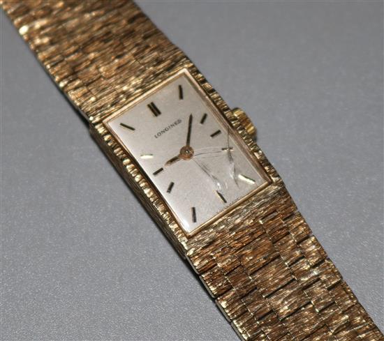 A ladys 1970s textured 9ct gold Longines manual wind wrist watch.